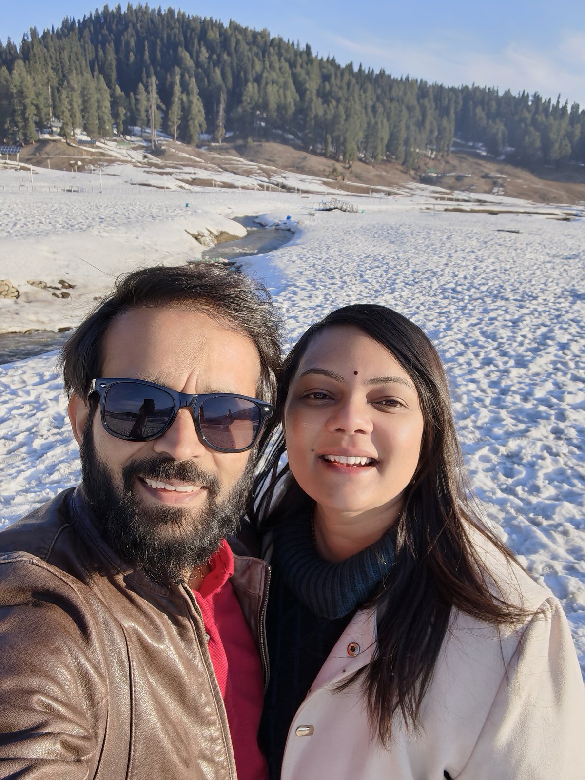 Komal and Piyush by the stream at Gulmarg